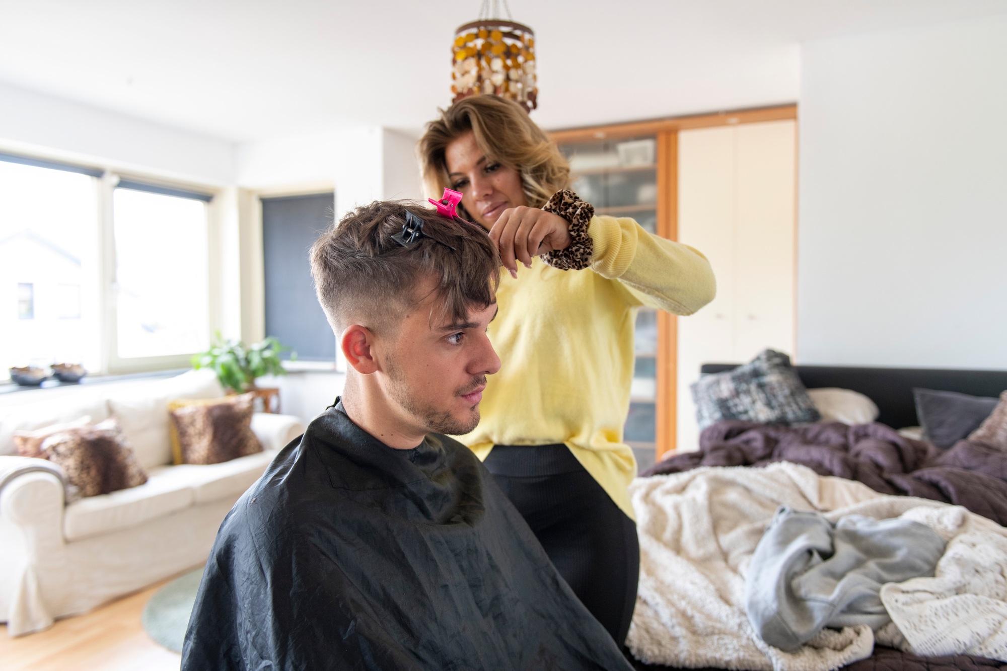Stylist giving a haircut at home
